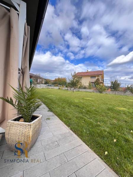 Rodinný dom v obci Dubová s 920m2 rozsiahlym pozemkom  - Záhrada rodinného domu na Lipovej ulici v Dubovej s trávnikom a dláždeným chodníkom.