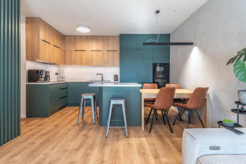 PRENÁJOM 3 izbový byt s predzáhradkou, BORY PROMENÁDA - Kuchyňa v 3-izbovom byte s podlahou s dreveným dekorom a jedálenským stolom.