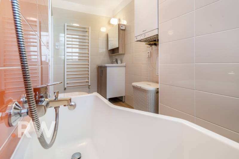 REWIN I Priestranný 3 izbový byt v tichej lokalite Senca - Kúpeľňa s vaňou, rebríkovým radiátorom a skrinkou v 3-izbovom byte.