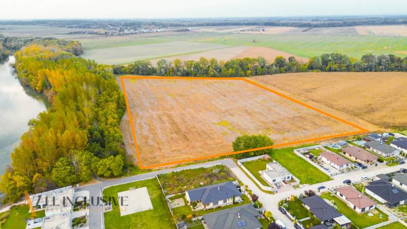 NA PREDAJ INVESTIČNÝ STAVEBNÝ POZEMOK, JAHODNÁ - Letecký pohľad na developerské pozemky v meste Jahodná obklopené prírodou a riekou.