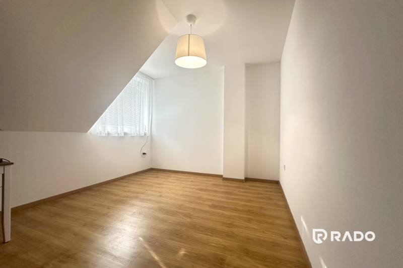 RADO| Podnikajte a zároveň bývajte pod jednou strechou! - Miestnosť v rodinnom dome s podlahou s dreveným dekorom, jednoduchou lampou a veľkým oknom.