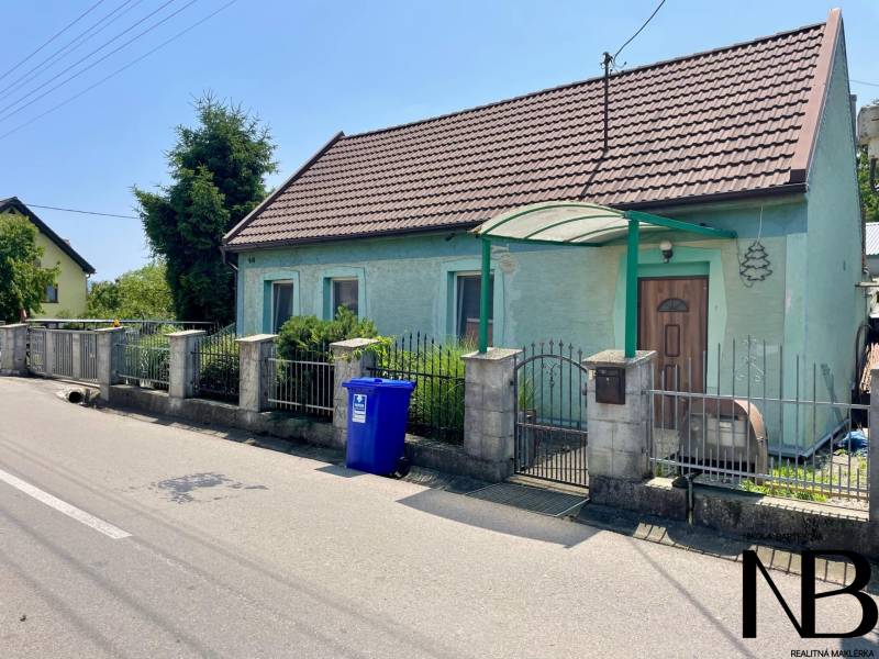 Na predaj rodinný dom s podnikateľským potenciálom, TN-Záblatie - Rodinný dom na Záblatskej ulici v Trenčíne so záhradou a modrou nádobou na odpad.