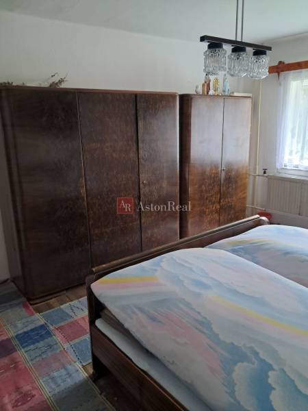 CHALUPA v rekreačnej oblasti ZÁZRIVÁ - 5km od Terchovej - Spálňa v rodinnom dome s posteľou, skriňami a koberec s farebným vzorom.