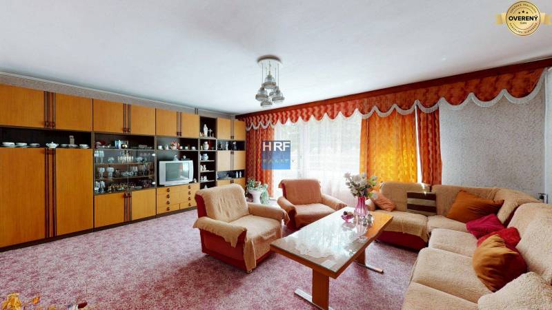 Na predaj rod. dom v obci Radošovce - Vieska, okr. Skalica. - Obývacia izba v Rodinnom dome so sedacou súpravou, obývačkovou stenou a kvetmi.