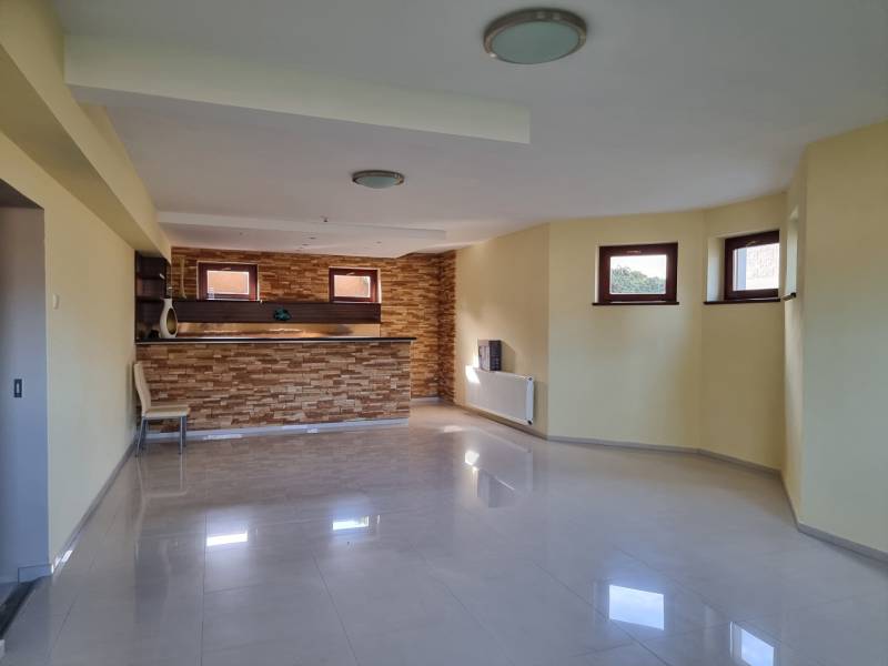 EXKLUZÍVNA VILA - NITRA - PREDAJ - Otvorený priestor s barovým pultom a oknami v rodinnom dome, svetlé steny a podlahy.