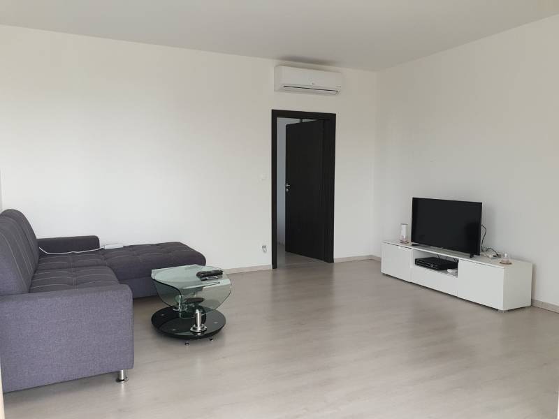 PRENÁJOM - Byt s krásnym výhľadom - Nitra, Dolnohorská - Obývačka v 2-izbovom byte s pohodlnou sedačkou a podlahou s dreveným dekorom.