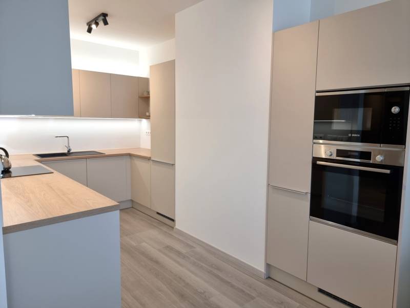 PRENÁJOM - 3 izbový byt Nitra – RIVIERA NITRA, Piesková ulica - Moderná kuchyňa v 3-izbovom byte s drevenou pracovnou doskou a vstavanými spotrebičmi.