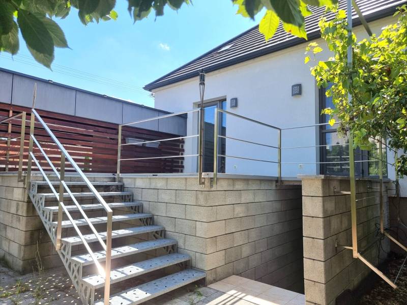 PREDAJ - 3 izbový dom v centre mesta, Nitra - Exteriér rodinného domu v Nitre s terasou a schodiskom z kovu a betónu.