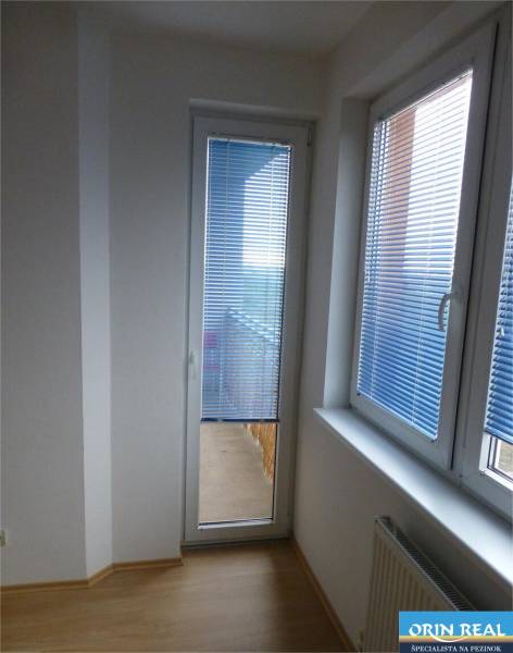Na predaj 2 izbový byt s parkovacím státím Zemplínska ul. - Sklenené dvere s žalúziami, radiátor a podlaha s dreveným dekorom v 2-izbovom byte.