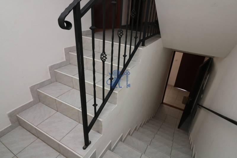 ZNÍŽENÁ cena - viacgeneračný  rodinný dom v Borinke  - Schodisko s kovovým zábradlím vedie do chodby v rodinnom dome na ulici.