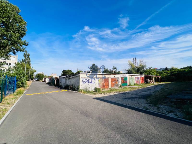 Ponúkame na prenájom Garáž na Skalickej ul. Nové Mesto - Garáže na Skalickej ceste v Bratislave - Novom Meste, obklopené zeleňou a asfaltovou cestou.