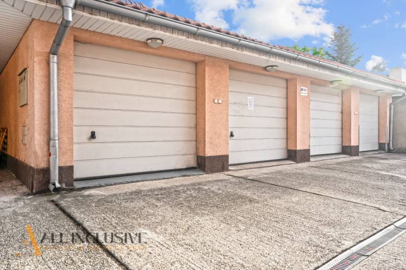 NA PREDAJ 2-IZBOVÝ BYT S 2 BALKÓNMI, DUNAJSKÁ STREDA - Garáže na Kukučínovej ulici v Dunajskej Strede s betónovou plochou a strešnými svetlami.
