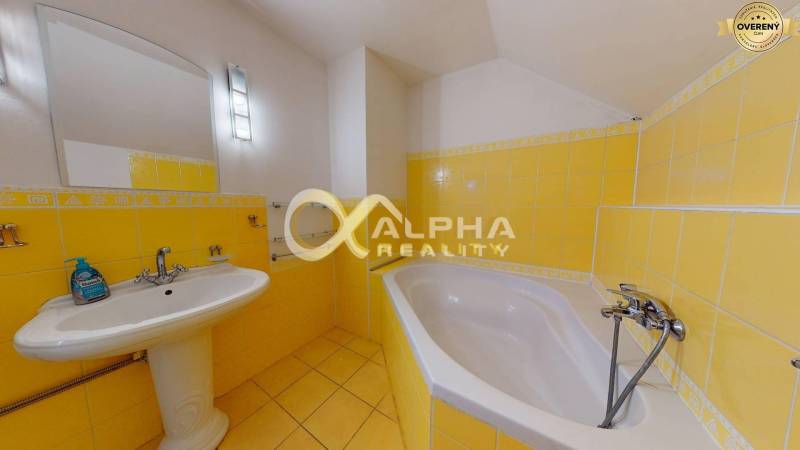 Prenájom priestorov, centrum, Spišská Nová Ves - Žltá kúpeľňa s vaňou, umývadlom a veľkým zrkadlom.