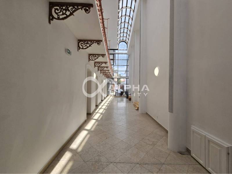 Prenájom obchodných priestorov, 268m2, Letná ulica, Spišská Nová Ves - Presklený interiér obchodných priestorov so zdobenými konzolami a kamennou podlahou.