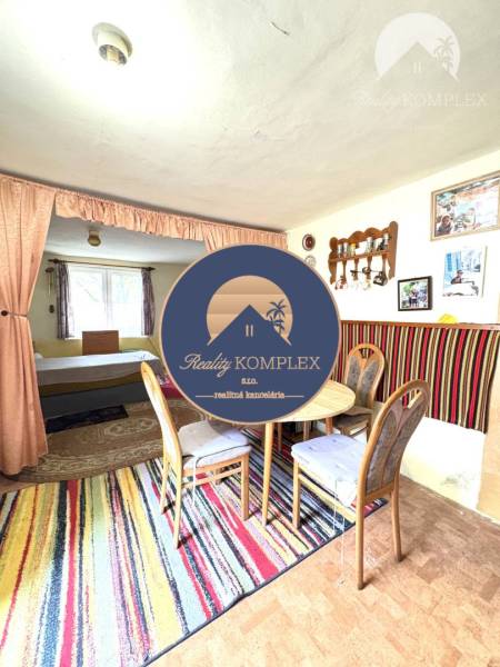 IBA U NÁS !!! ponúka EXKLUZÍVNE na predaj rodin - Jedáleň v rodinnom dome s farebným kobercom a dreveným nábytkom.