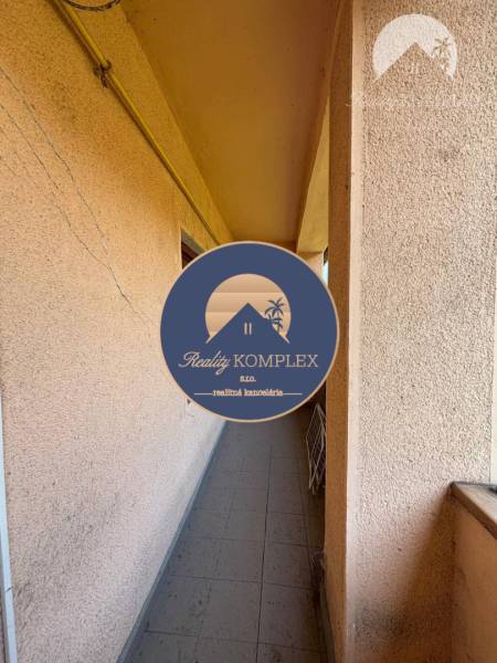 Reality KOMPLEX Vám ponúka EXKLUZÍVNE na predaj rodinný dom, ktorý sa  - Úzky balkón rodinného domu vo Veľkom Mederi s plastovým potrubím na stene.