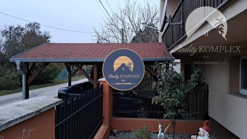 !!! LEN U NÁS!!! Vám ponúka NA PREDAJ rodinný d - Rodinný dom na Hlavnej ulici v Kostolných Kračanoch s prístreškom a záhradnými dekoráciami.