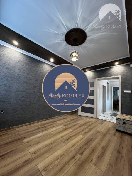 Vám ponúka na PREDAJ kompletne zrekonštruovaný  - Izba v rodinnom dome s podlahou s dreveným dekorom, zaujímavými svetelnými prvkami a dekoratívnym stropom.