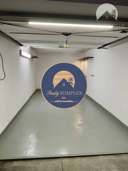 Prenájom garáže v Dunajskej Strede – podzemná garáž - Priestranná garáž s bielymi stenami a sivou podlahou vyžaruje čistotu a poriadok.