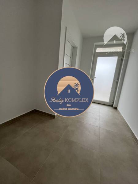 Vám ponúka na predaj moderný 4-izbový bungalov - Pohľad na vstupnú chodbu v rodinnom dome s dlažbou v Topoľníkoch.