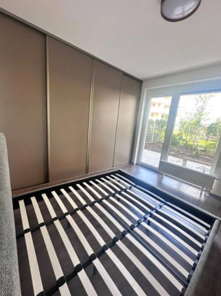 Na prenájom 2iz. byt s predzáhradkou  - Spálňa v 2-izbovom byte s posteľou a vstavanej skrine s výhľadom do záhrady.