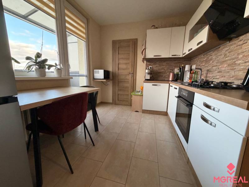 4 izbový byt s balkónom  Topoľčany / VYPLATENA ZALOHA - Kuchyňa v 4-izbovom byte s oknom, rastlinami, kuchynskou linkou a vstavanými spotrebičmi.