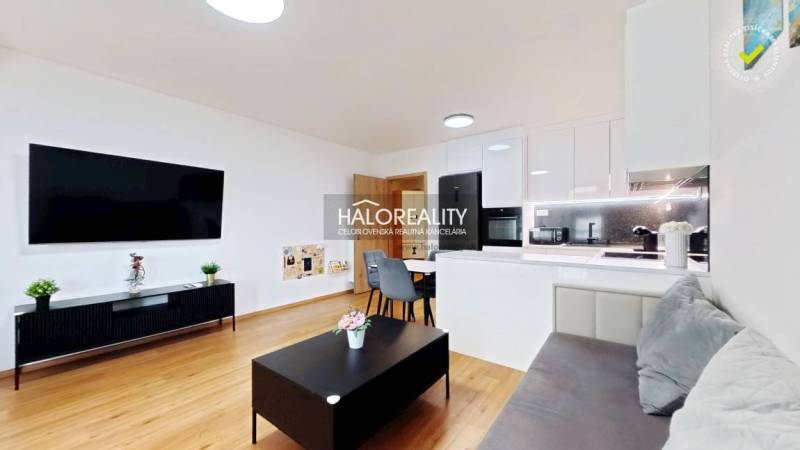 Predaj, dvojizbový byt Bratislava Ružinov, Trnavská ... - Obývacia izba v 2-izbovom byte, svetlý interiér, kuchynská linka, podlaha s dreveným dekorom.