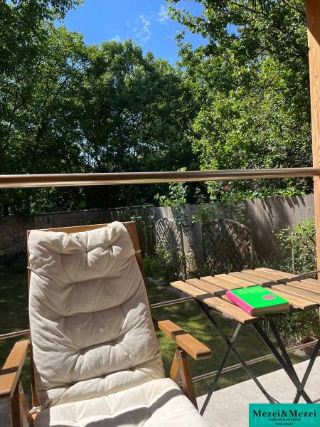 Na predaj moderný 4-izbový byt s veľkou terasou a súkromnou záhradou - Relax na terase domu v Bratislave - Vrakuni s ležadlom a stolíkom pod modrou oblohou.