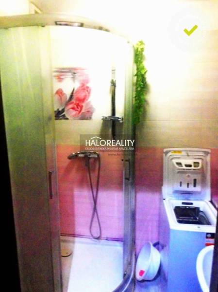 Predaj, dvojizbový byt Topoľčany, Centrum - Kúpeľňa v 2-izbovom byte so sprchovým kútom a práčkou, farebne ladená do ružova.