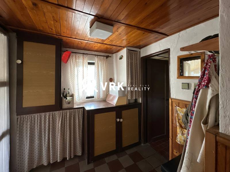 RODINNÝ DOM - CHALUPA, KALŠA - Interiér rodinného domu s dreveným stropom a závesmi, útulný kútik s dekoračnými prvkami.