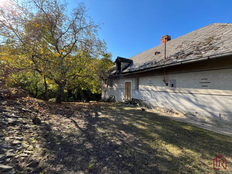 Rákoš - stavebný pozemok s projektom, možný odpočet DPH - Dvor s domom v Rákoši, obklopený zeleňou. Pozemky - bývanie.