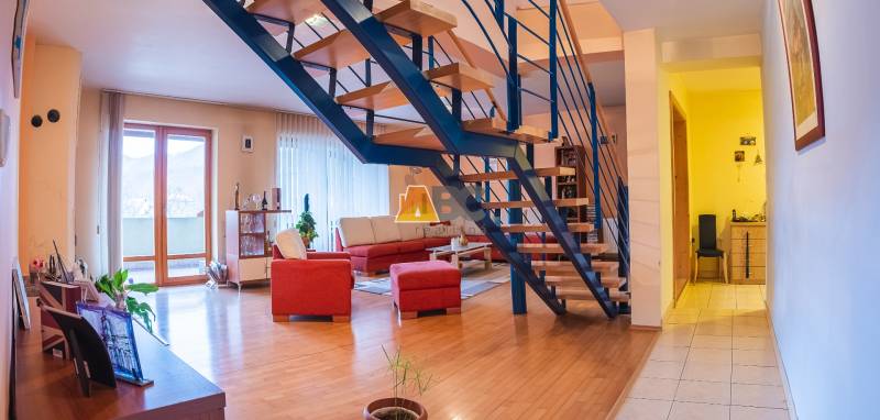 Obrovská vila pre luxusný život aj podnikanie (pripravujeme) - Interiér Vily s podlahou s dreveným dekorom, schodiskom a červenou sedacou súpravou.