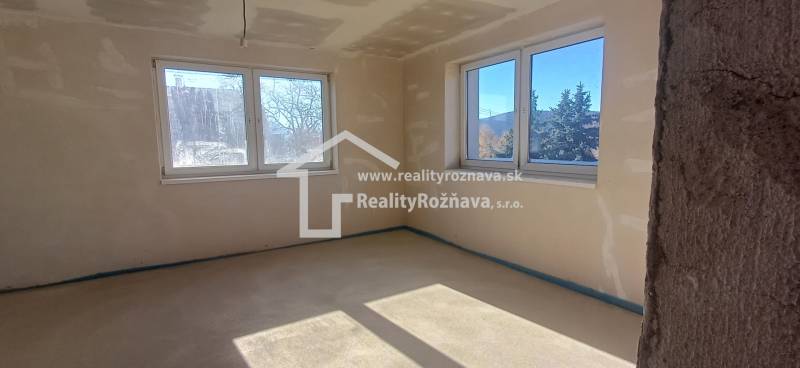 PREDAJ/ Kompletne zrekonštruovaný rodinný dom v Rožňave - Interiér rodinného domu so svetlou podlahou a veľkými oknami pre dostatok svetla.