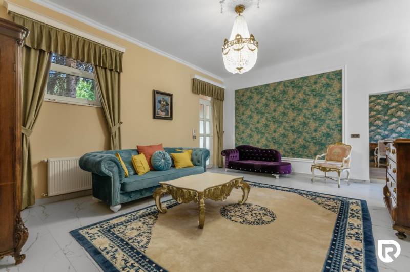 Exkluzívna honosná kúria | 3 ha pozemok | Dunakiliti - HU - Interiér zariadený farebnými sedačkami, lustrom a koberecom, Zvláštne nehnuteľnosti.