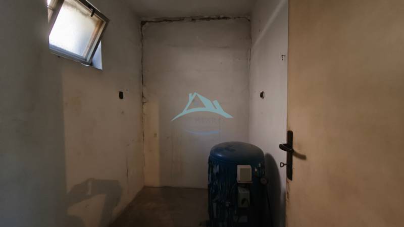 Rodinný dom v obci Čebovce v okrese Veľký Krtíš. - Prázdna miestnosť s oknom a nádržou v rodinnom dome.