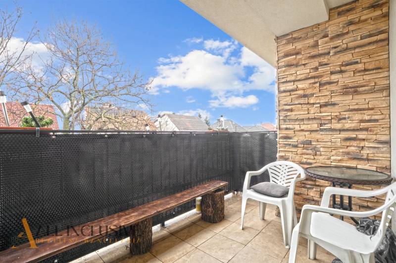 REZERVOVANÉ | NA PREDAJ 3-IZBOVÝ BYT S BALKÓNOM, VRAKÚŇ - Balkón 3-izbového bytu vo Vrakúni so sedením, tehlovým obkladom a výhľadom na strechy.