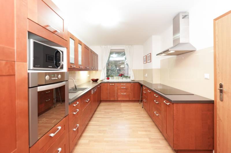 ViNi real / TOP PONUKA! Moderný 4-izb. bungalov s garážou, KVETOSLAVOV - Kuchyňa v rodinnom dome s dreveným dekorom, s varnou doskou a mikrovlnnou rúrou.