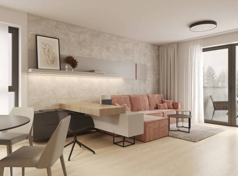 Prémiové byty s vysokým investičným potenciálom - Obývacia izba s béžovou stenou, ružovým gaučom a podlahou s dreveným dekorom.