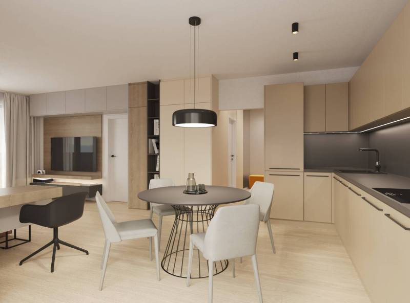 Prémiové byty s vysokým investičným potenciálom - Osvetlená obývacia izba s kuchynským kútom, moderným nábytkom a podlahou s dreveným dekorom.