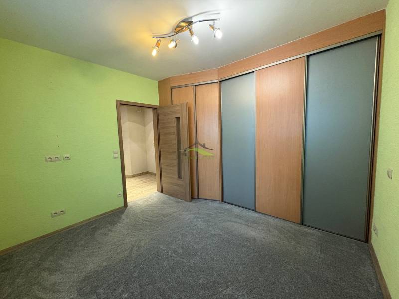 NOVINKA .... Na  predaj 3 izbový byt na sídlisku SNP v Michalovciach - Izba v 3-izbovom byte s farebnou stenou, skriňou a svetlým osvetlením.