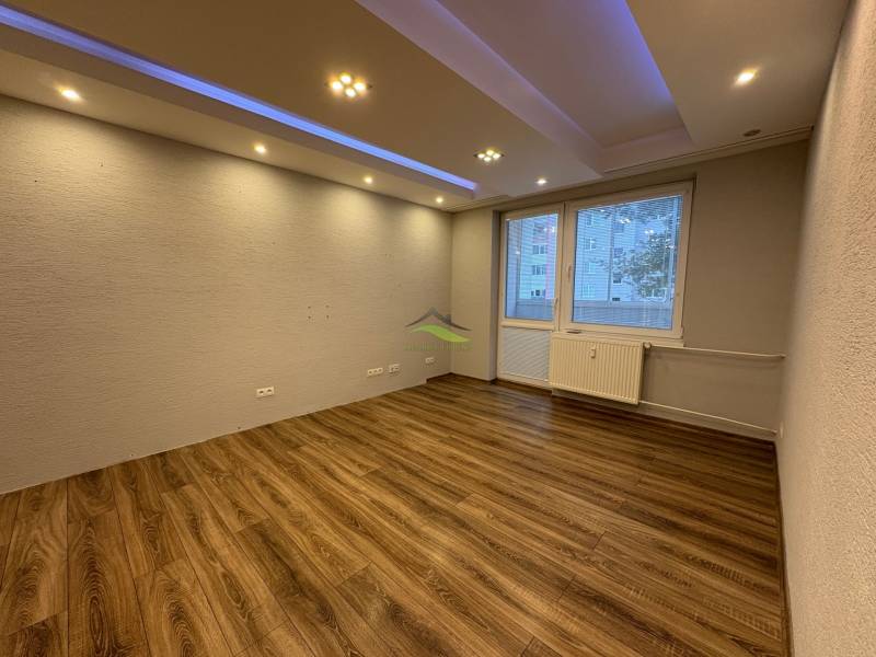 NOVINKA .... Na  predaj 3 izbový byt na sídlisku SNP v Michalovciach - Izba v 3-izbovom byte s podlahou s dreveným dekorom a bodovým osvetlením.