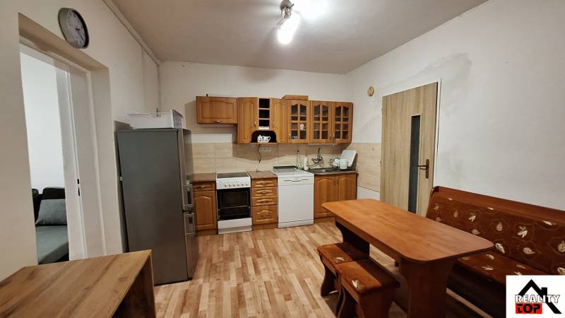 Rodinný dom po čiastočnej rekonštrukcii - Kuchyňa v rodinnom dome s dreveným dekorom a klasickým nábytkom.