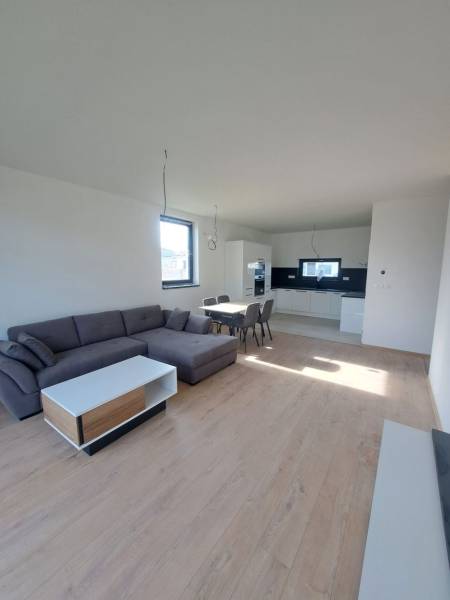 REZERVOVANÉ! Posledná novostavba 4-izbového dvojdomu v štandarde - Obývačka v rodinnom dome s kuchyňou, sedačkou a podlahou s dreveným dekorom.