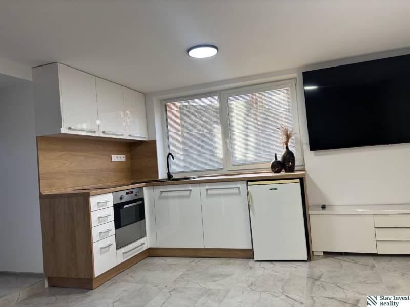 Dom za cenu bytu- komplet prerobený RD 3 izb. Blatné  - Kuchyňa v rodinnom dome s bielymi skrinkami a dekorom dreva.