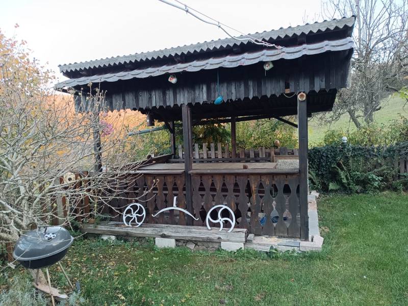 Samota Nová Baňa – Štále s hospodárskymi stavbami  - Drevený altánok s dekoráciami a grilom na záhrade pri rodinnom dome.