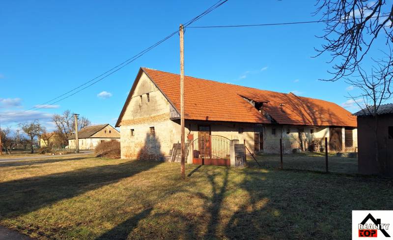 Všetko po čom túžite - dom, relax, kúpele, kúpalisko - Kamenný rodinný dom v Orávke s červenou strechou obklopený trávnatým pozemkom.