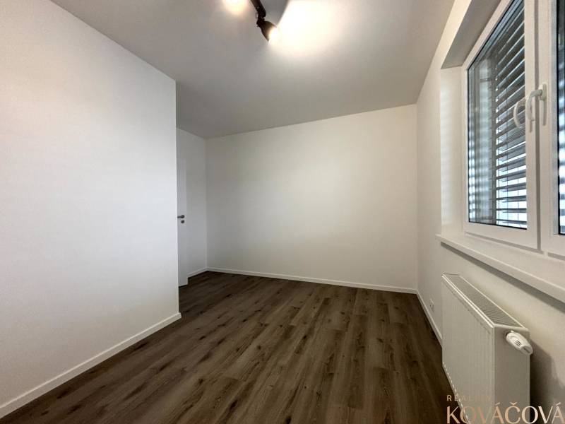 Na prenájom 3 izb. byt, Trenčín, ul.Vl.Predmerského, park.miesto,garáž - Svetlá miestnosť s podlahou s dreveným dekorom v 3-izbovom byte.