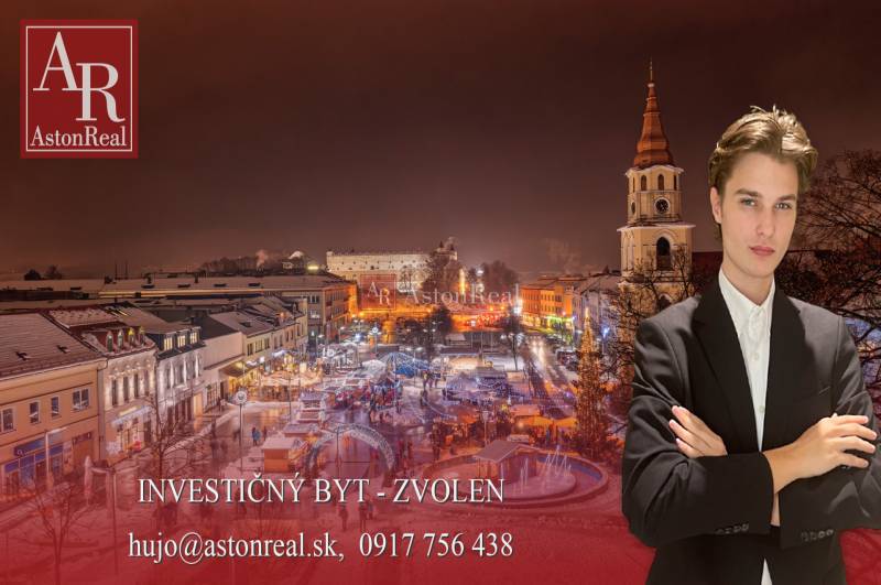 INVESTIČNÁ PRÍLEŽITOSŤ VO ZVOLENE – 1i BYT S BALKÓNOM, STÁLYM NÁJOM - Zimná večerná atmosféra v centre Zvolena so zasneženými strechami a rozsvietenými ulicami.
