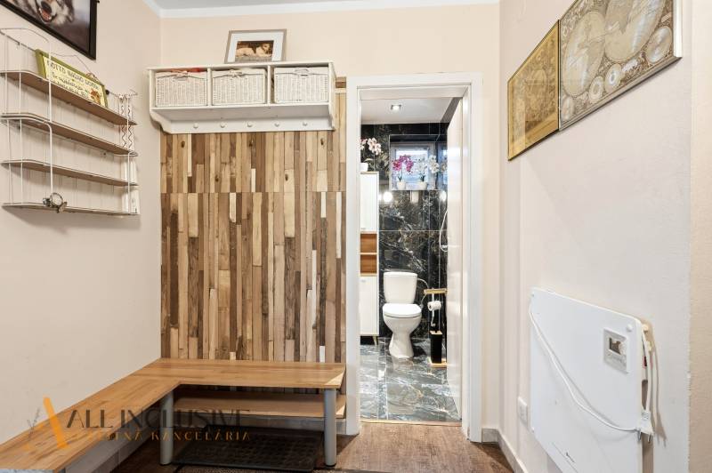 Na predaj 4-izb. rodinný dom s garážou, Okoč - Chodba v rodinnom dome s podlahou s dreveným dekorom a pohľadom na toaletu.