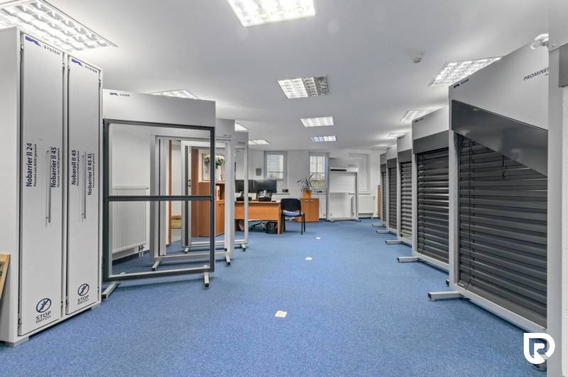 Kancelárie-Showroom 357 m², Zadunajská cesta, Petržalka, BA - Obchodné priestory s modrým kobercom, vystavené výrobky a kancelársky nábytok.
